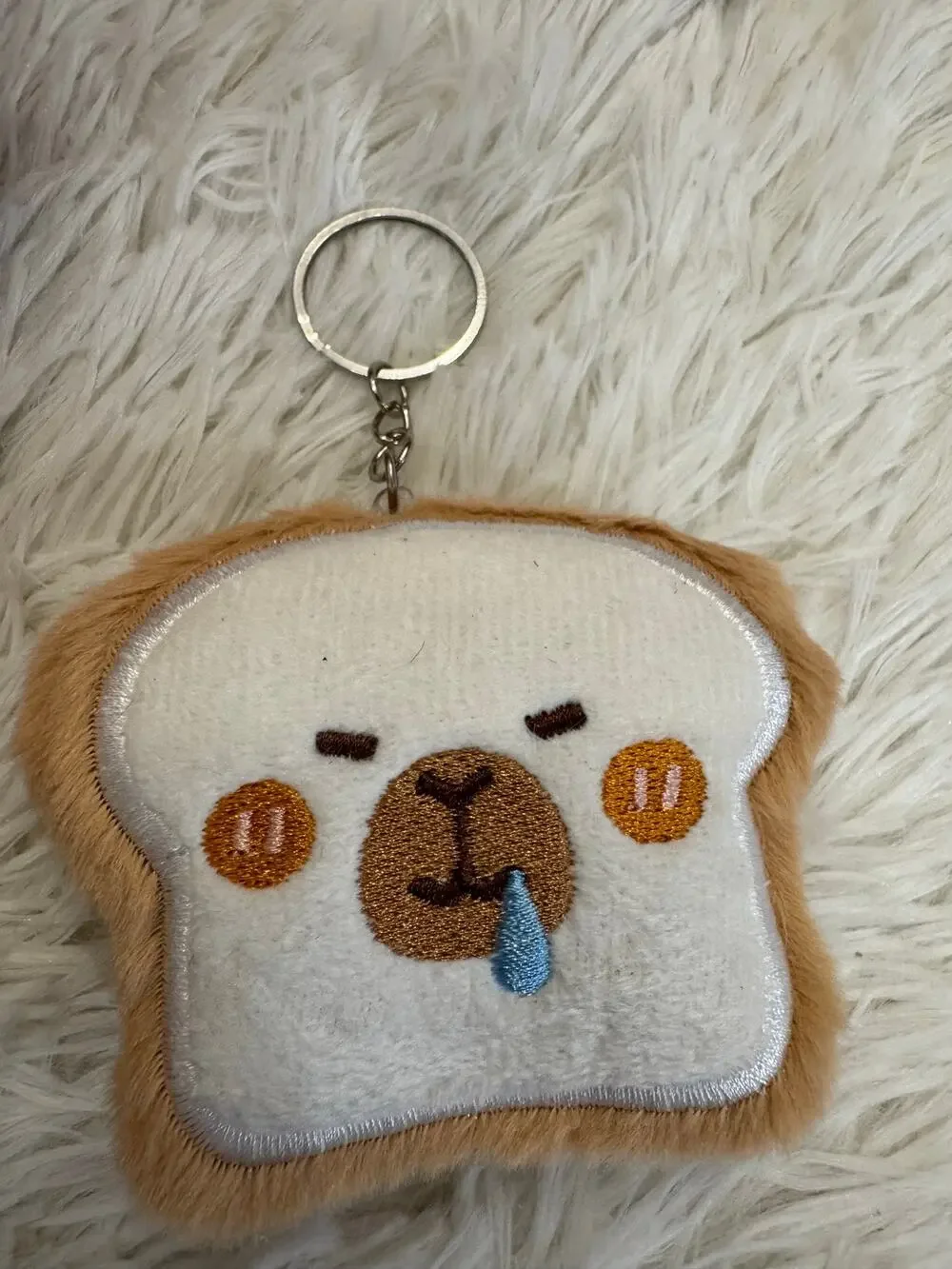 Capybara  bread  toast keychain with embroidered face on a slice of bread